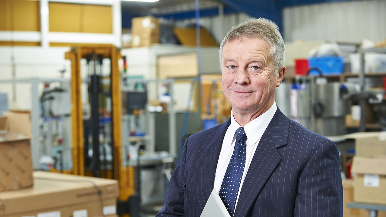 Businessman standing in warehouse