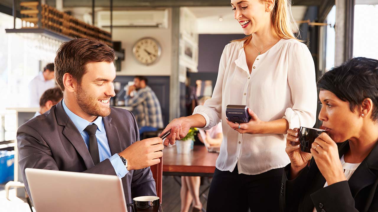 Businessman paying for lunch with a credit card