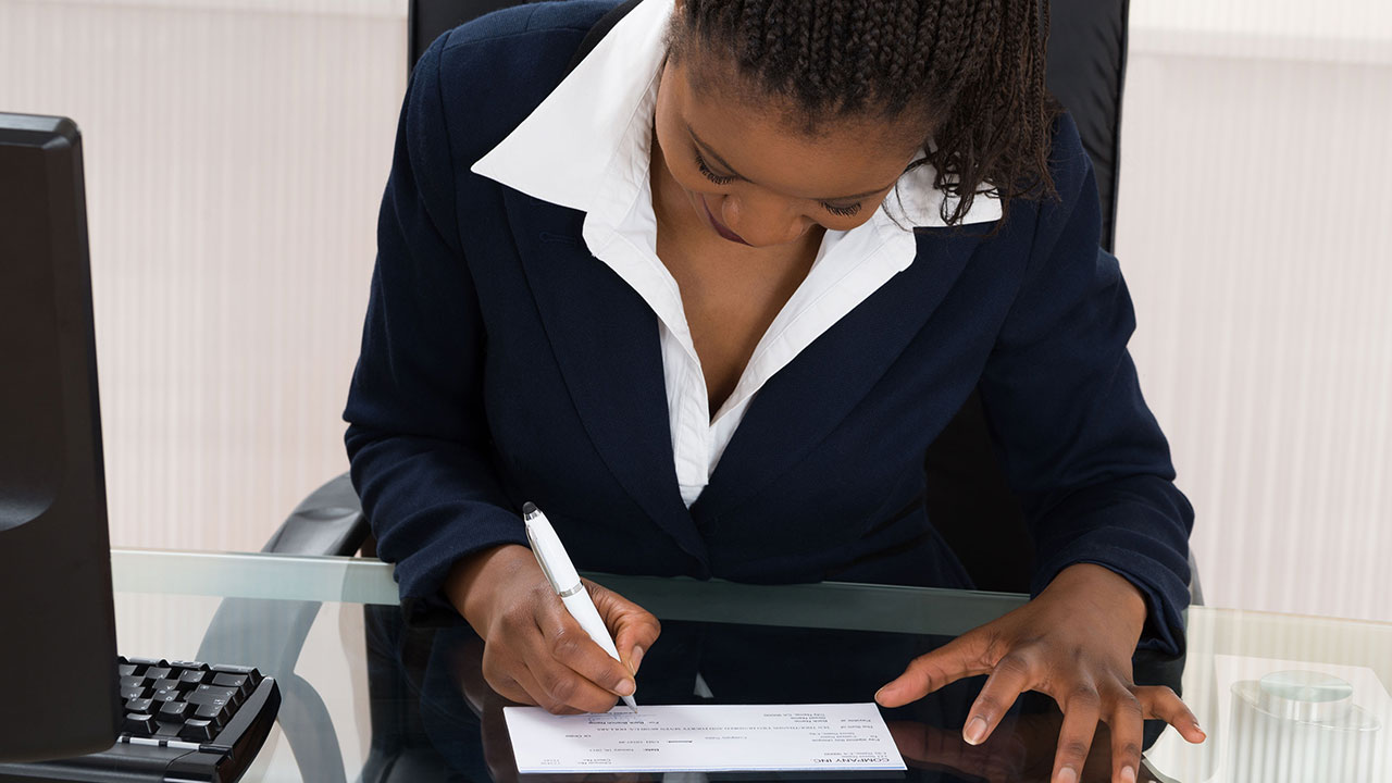 Businesswoman writing a check