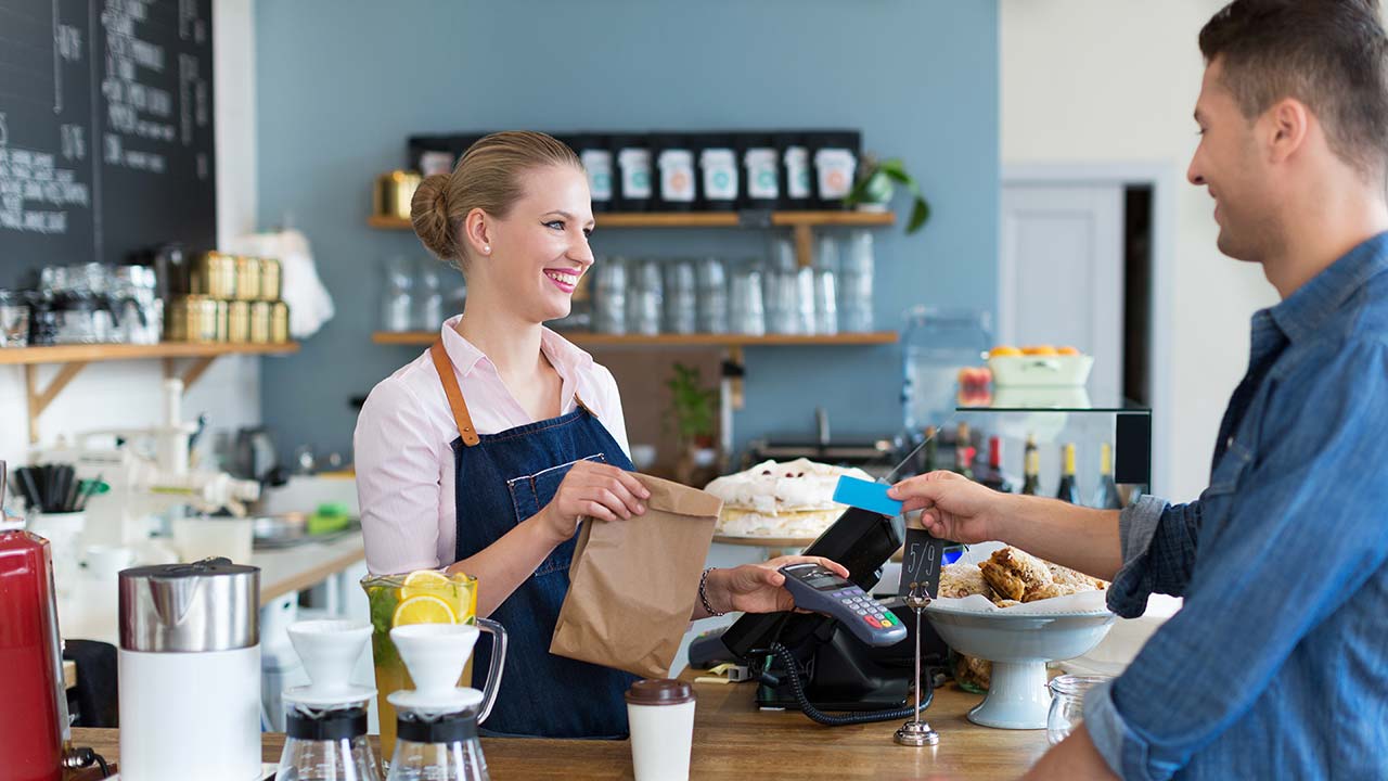 Female cashier taking a customer's credit card