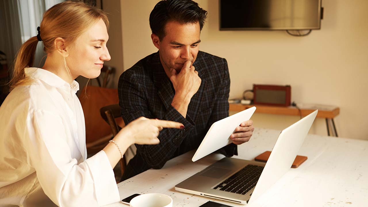 Couple at a table with a laptop