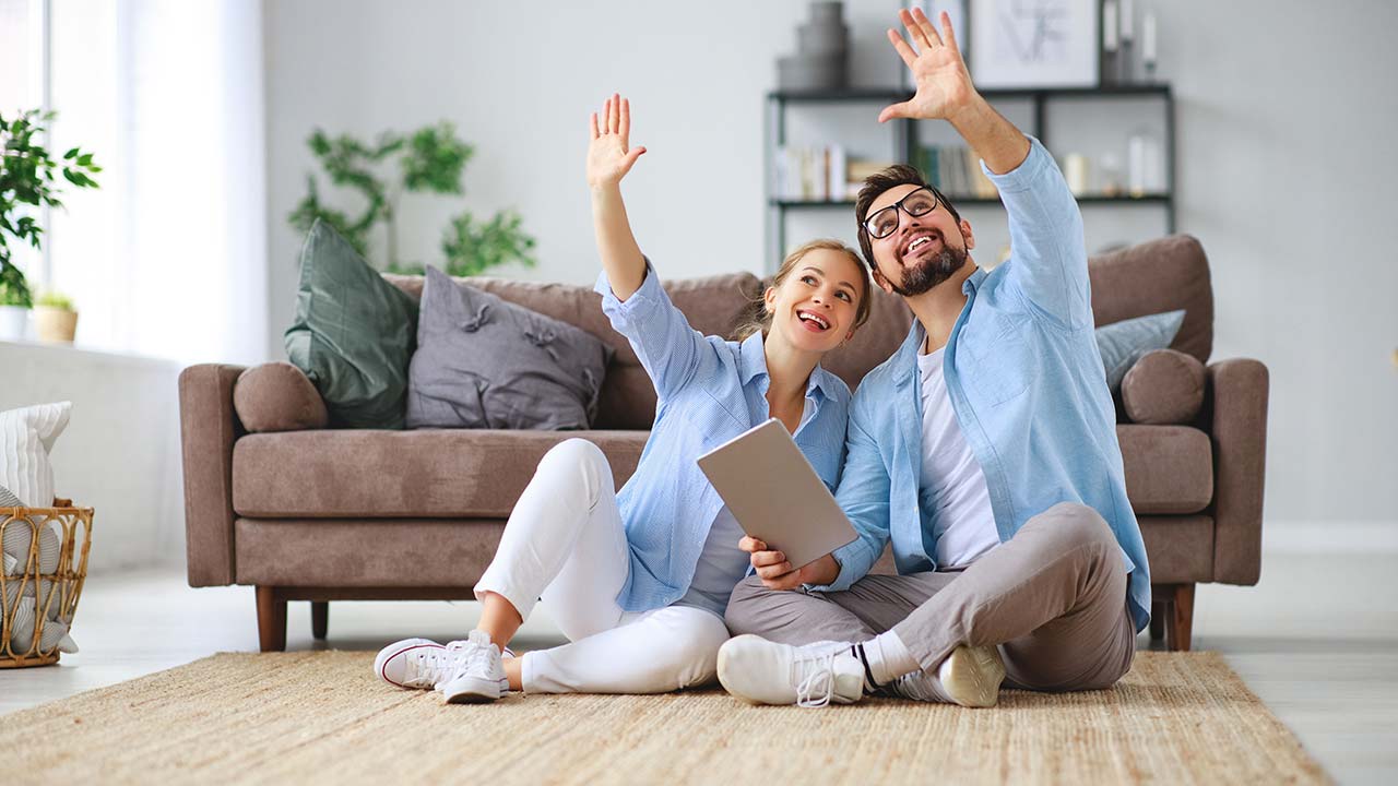 Couple sitting on the floor planning a redesign