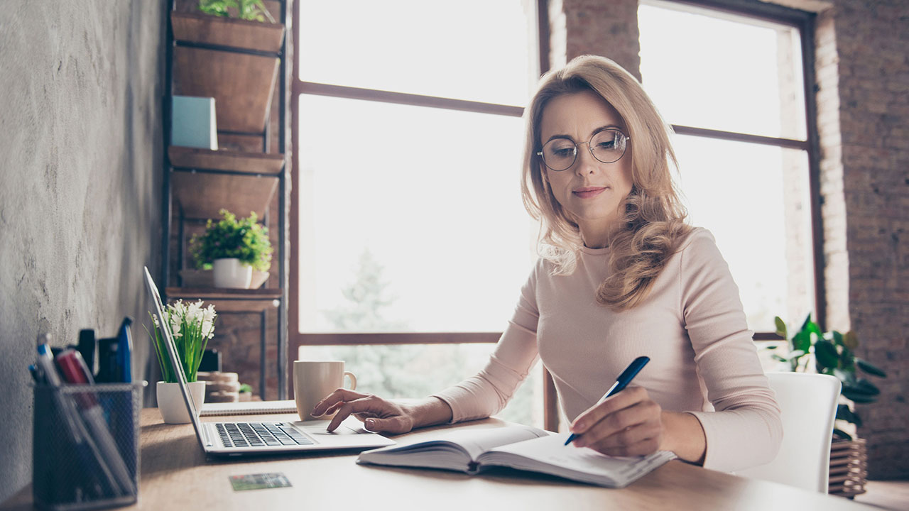 Woman at her desk working on laptop