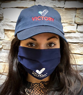 Amanda Bucci wearing the #igotmyshot hat and mask.